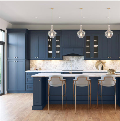 Modern kitchen with navy blue cabinets, white countertops, and pendant lights ( USA Cabinets Outlet )