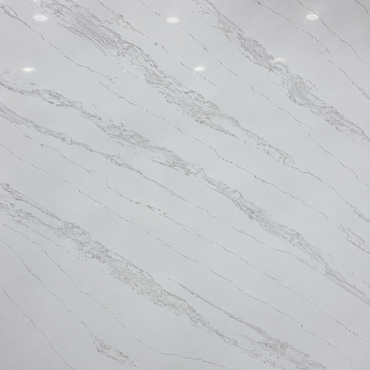 White marble-look tile or countertop surface with soft gray veining and a glossy finish, showing small overhead light reflections.| USA Cabinets Outlet 