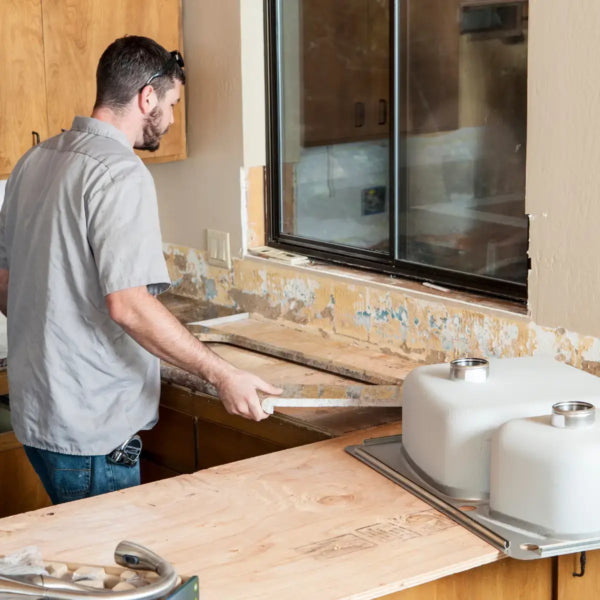 Professional installing a kitchen countertop during a cabinet renovation project. ( USA Cabinets Outlet )