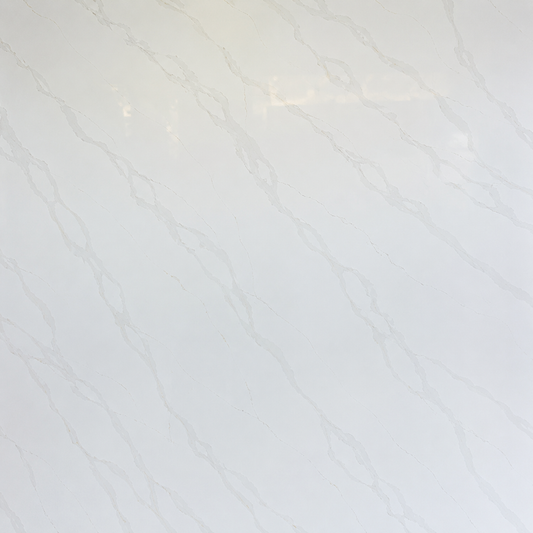 A close-up of a glossy white surface with delicate, light gray marble or quartz vein patterns.| USA cabinets Outlet 