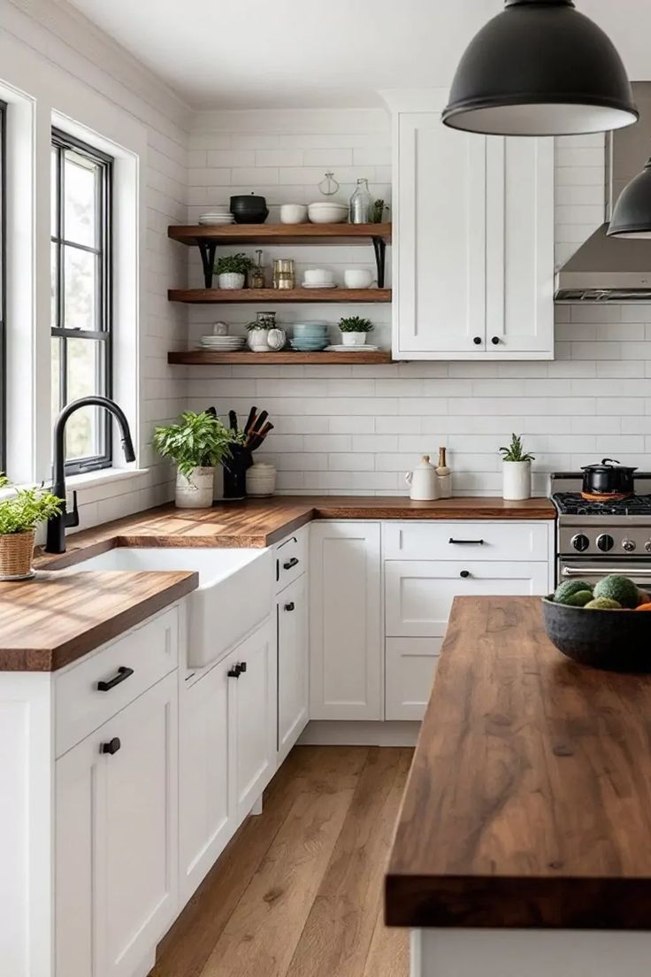 Modern kitchen with white cabinets, wooden countertops, and black fixtures ( USA Cabinets Outlet )