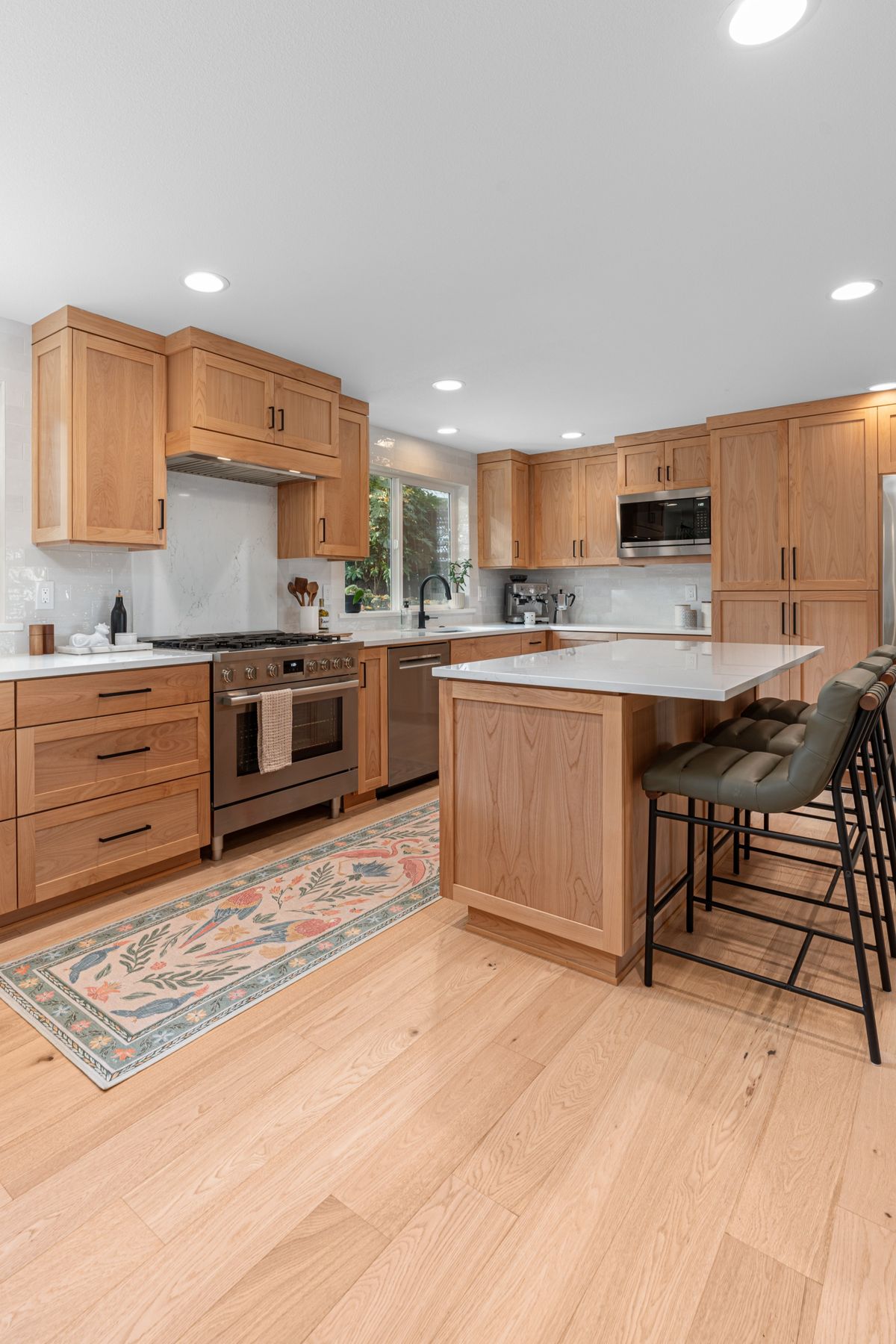 Modern kitchen with wooden cabinets, island, and stainless steel appliances ( USA Cabinets Outlet)