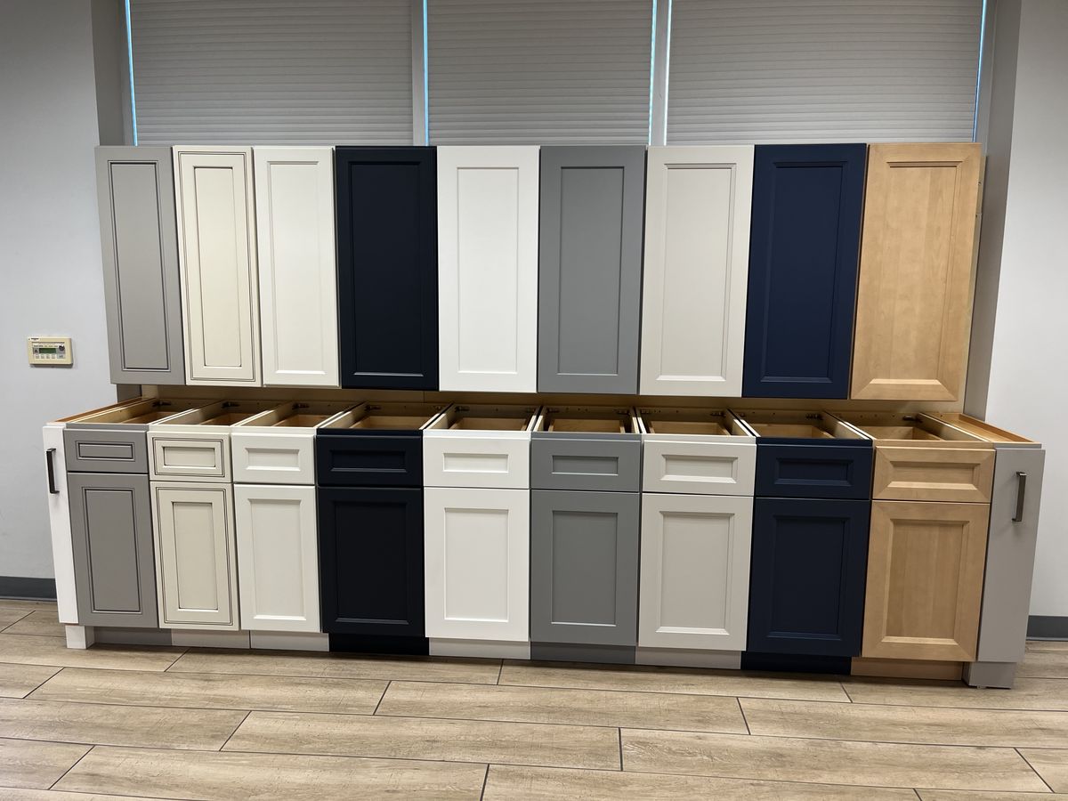 A showroom display showcasing kitchen cabinets in diverse colors, styles, and finishes. ( USA cabinets Outlet) 