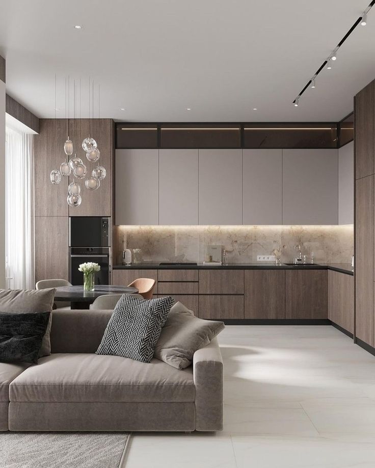 Modern living room with a gray sofa and kitchen in the background ( USA Cabinets Outlet )