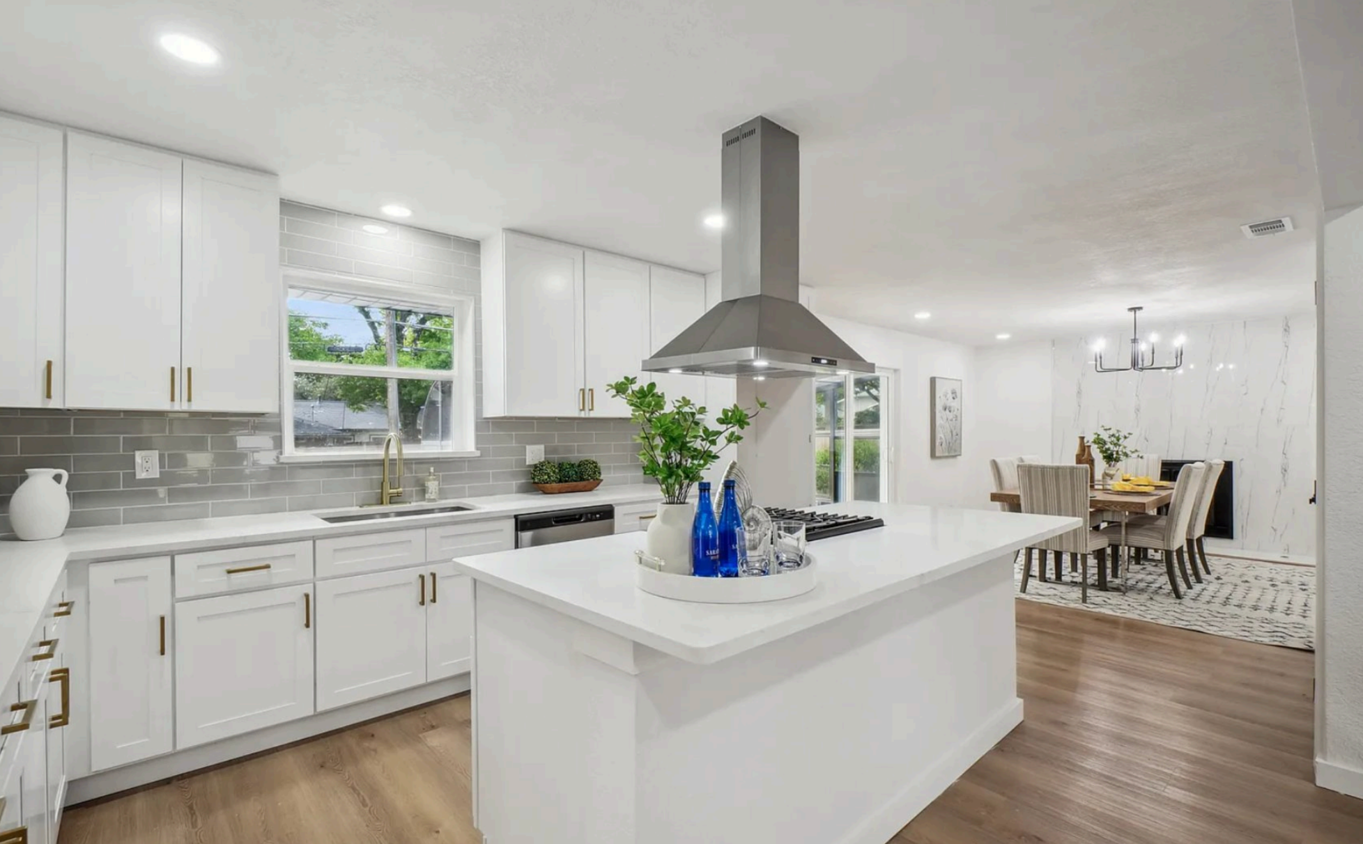 Modern kitchen with white cabinets, island, and stainless steel appliances ( USA Cabinets Outlet )